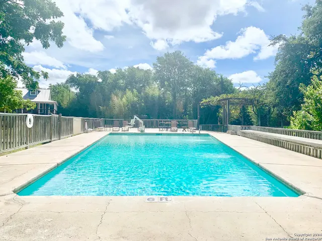 a view of a swimming pool with a yard