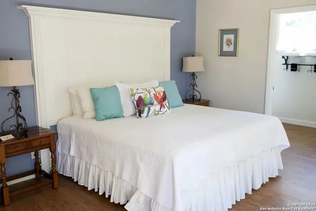 a bedroom with a bed and a lamp on table