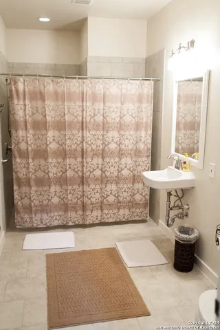 a view of bathroom with bathtub and shower