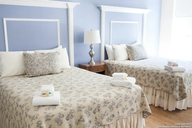 a bedroom with a bed and a wooden floor