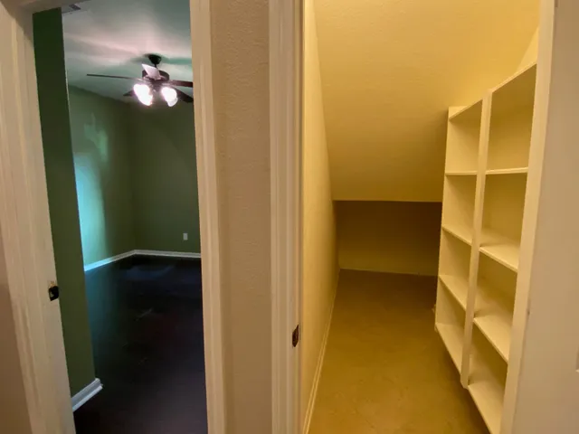 a bathroom with a granite countertop sink toilet and mirror
