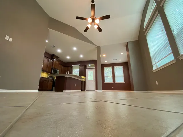 a large room with windows and chandelier