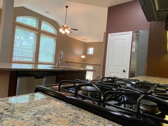 a kitchen with a stove and a chandelier