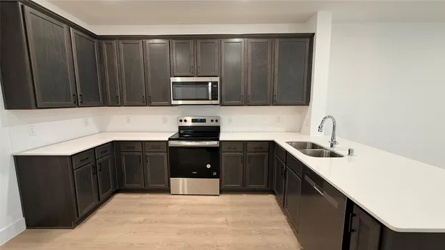 a kitchen with a sink and a stove top oven