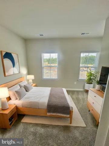 a bedroom with a bed and a couch