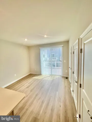a view of an empty room and wooden floor