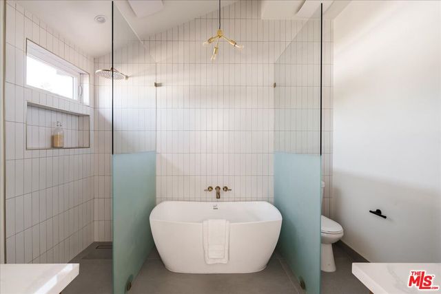 a white bath tub sitting next to a white toilet