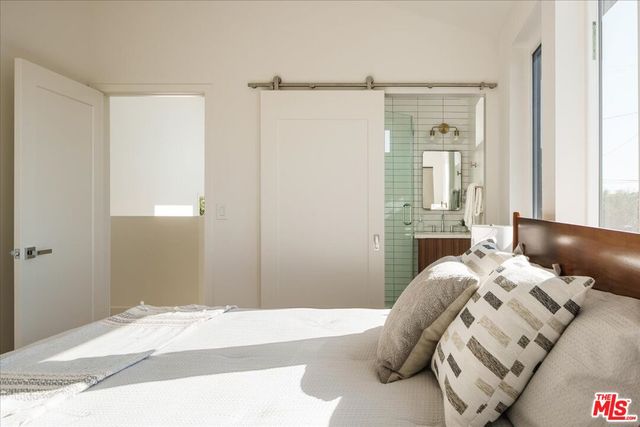 a bedroom with a bed and a mirror