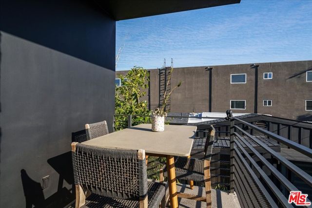 a view of a patio with table and chairs and potted plants