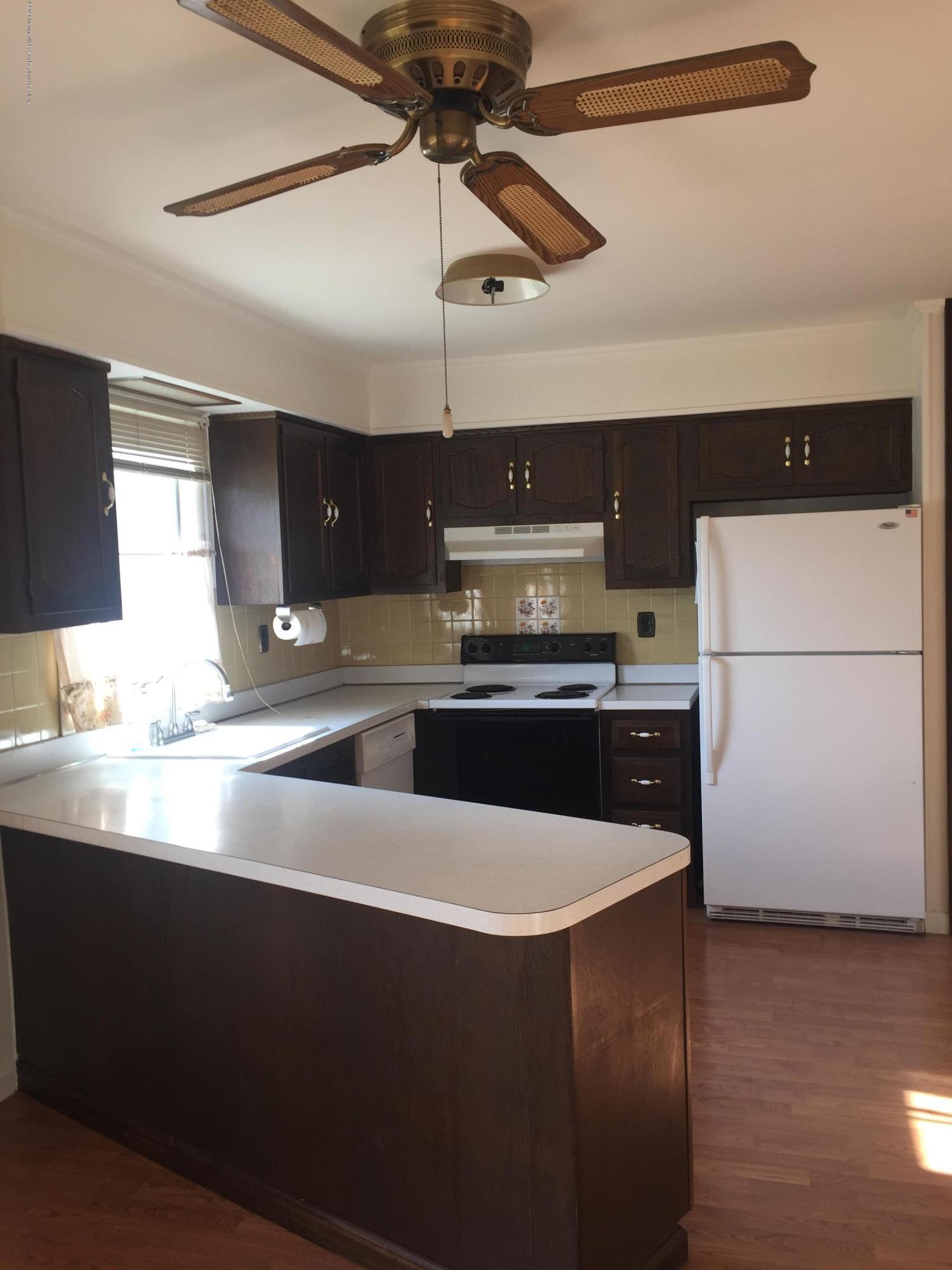 25 Lamb Road Brick, NJ 08724 - Photo 3 of 5 a kitchen with stainless steel appliances a refrigerator a sink and white cabinets