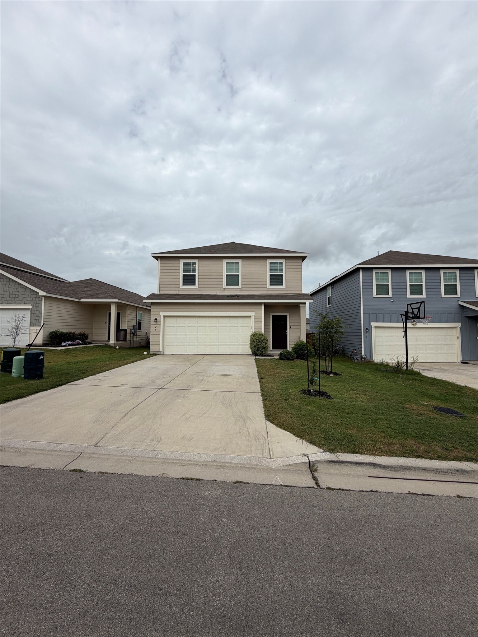 229-1 Night Riders Way Jarrell, TX 76537 - Photo 3 of 21 A well-kept lawn and paved driveway welcome you to this charming two-story residence.