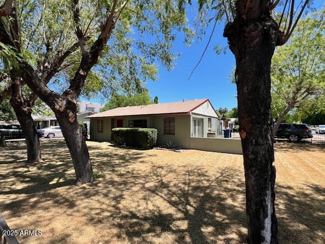 1321 South College Avenue Tempe, AZ 85281 - Photo 1 of 14 a white house that has a tree in front of a house