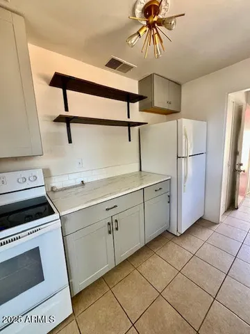 a kitchen with a stove cabinets and a sink