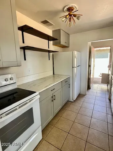 a kitchen with cabinets and appliances