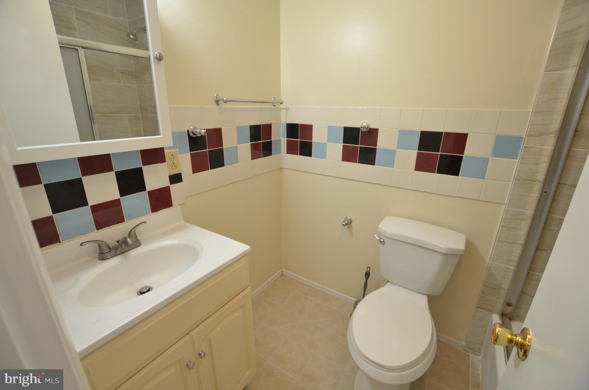 36 Steven Court, Unit 211 Gaithersburg, MD 20877 - Photo 16 of 24 a bathroom with a toilet a sink and a mirror