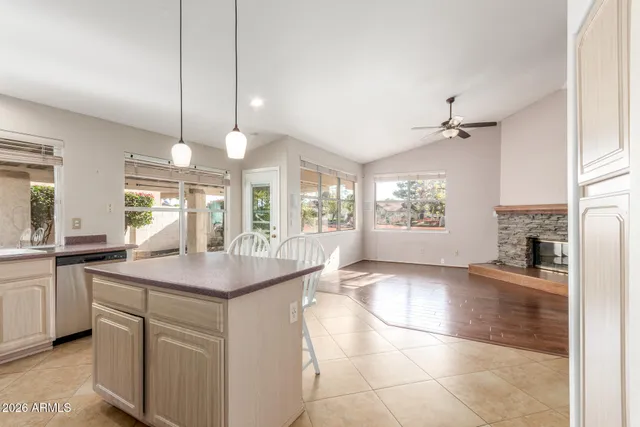 a kitchen with stainless steel appliances granite countertop a sink a stove and cabinets