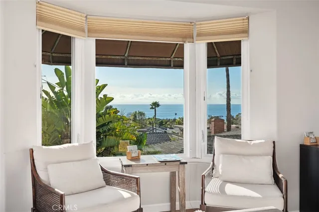 a dining room with furniture and a window