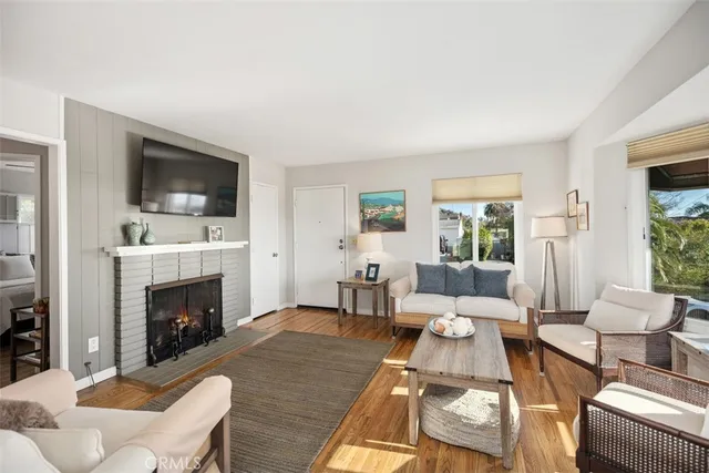 a living room with furniture fireplace and flat screen tv