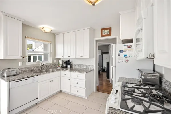 a kitchen with stainless steel appliances a sink stove and cabinets