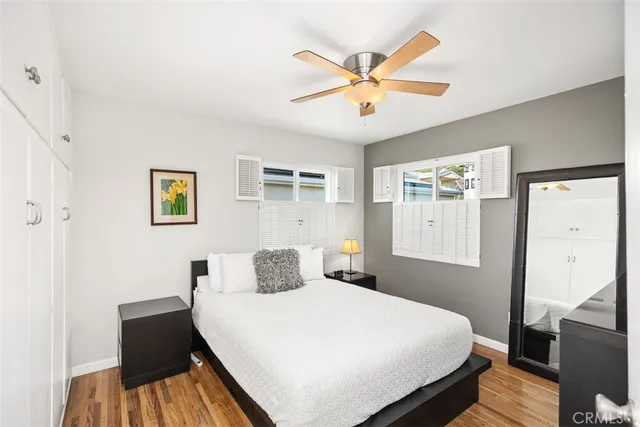 a bedroom with a large bed and a chandelier