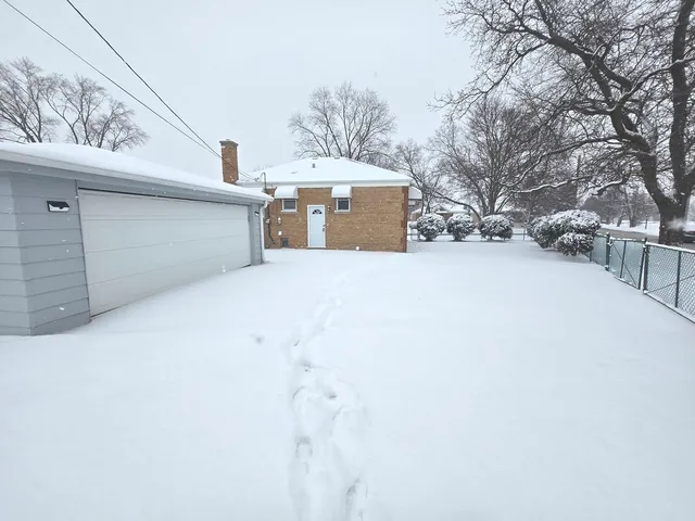 a view of a house with a snow in the yard