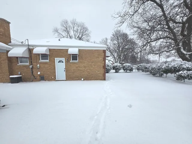 a view of a house with a snow in the yard