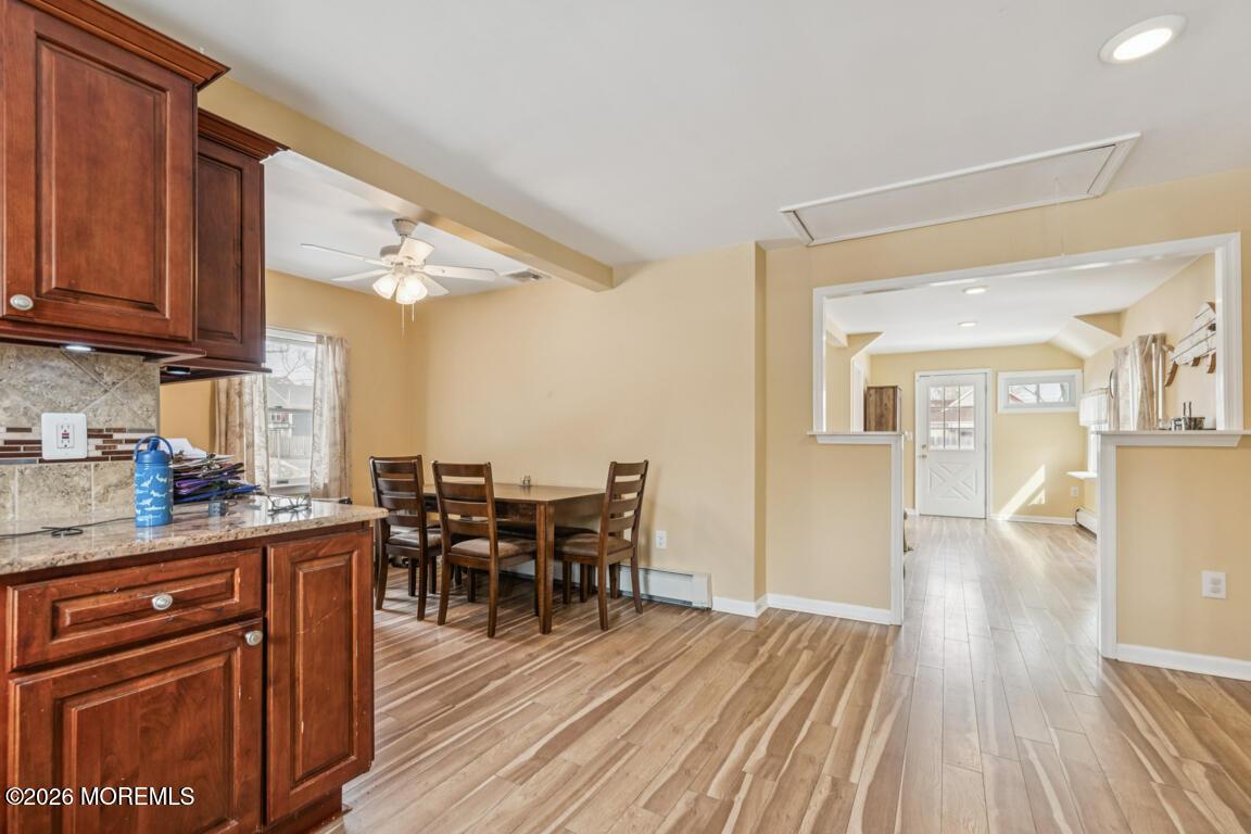 699 Mantoloking Road Brick, NJ 08723 - Photo 19 of 35 a kitchen with stainless steel appliances granite countertop wooden floors and wooden cabinets