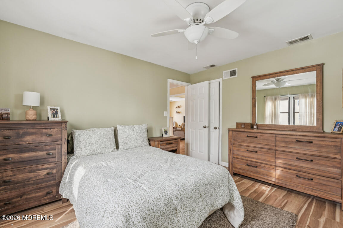 699 Mantoloking Road Brick, NJ 08723 - Photo 28 of 35 a bedroom with a bed and a dresser