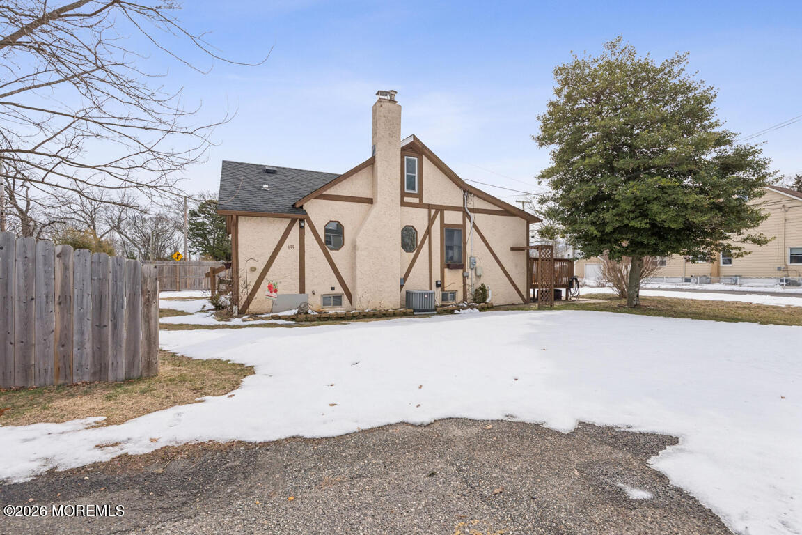 699 Mantoloking Road Brick, NJ 08723 - Photo 33 of 35 a wooden bench sitting in front of a building