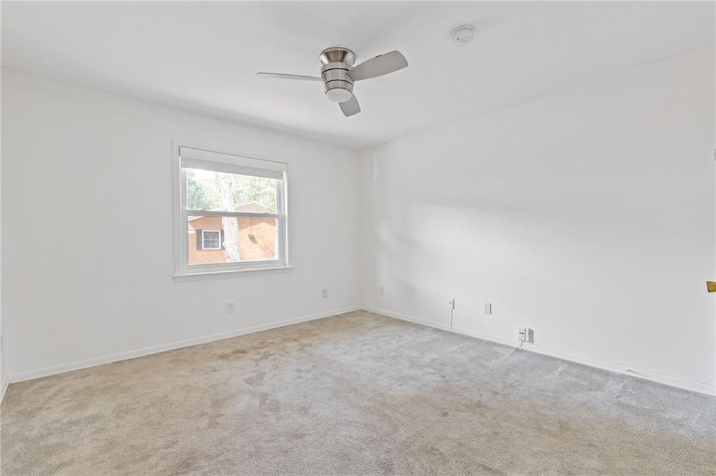 3510 Roswell Road, Unit C2 Atlanta, GA 30305 - Photo 11 of 24 an empty room with ceiling fan and window
