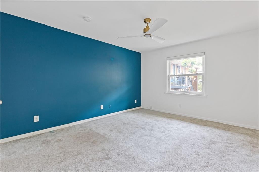 3510 Roswell Road, Unit C2 Atlanta, GA 30305 - Photo 14 of 24 an empty room with windows and ceiling fan