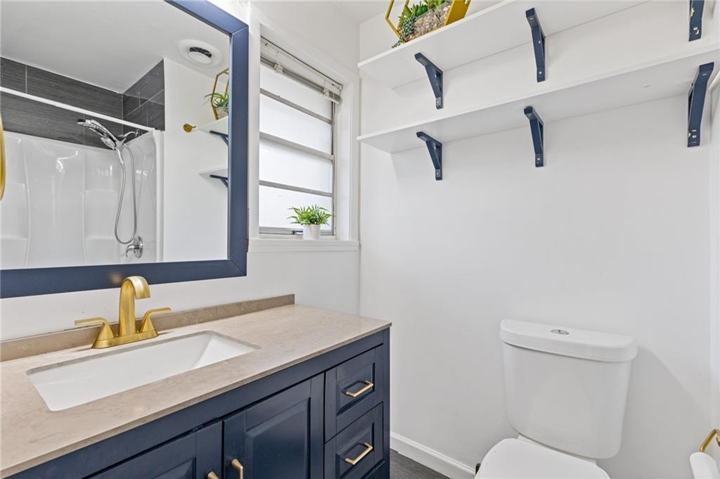 3510 Roswell Road, Unit C2 Atlanta, GA 30305 - Photo 16 of 24 a bathroom with a sink toilet a mirror and shower