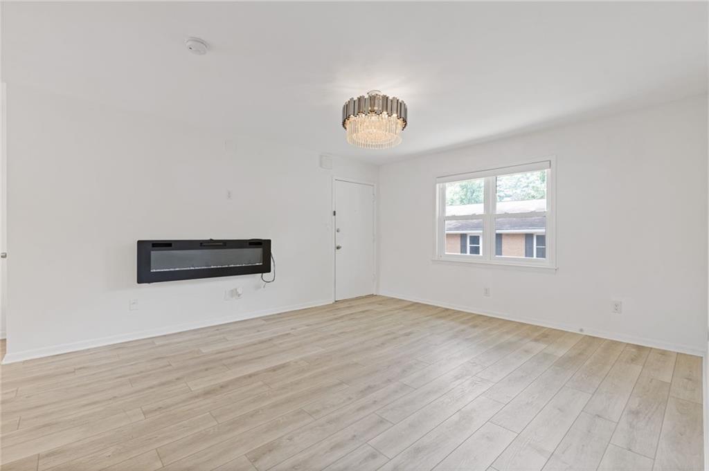 3510 Roswell Road, Unit C2 Atlanta, GA 30305 - Photo 6 of 24 a view of an empty room with a window and wooden floor