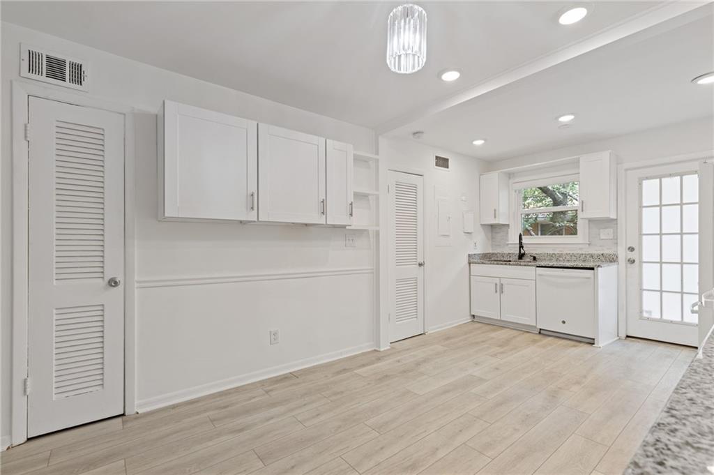 3510 Roswell Road, Unit C2 Atlanta, GA 30305 - Photo 8 of 24 a large white kitchen with window and stainless steel appliances