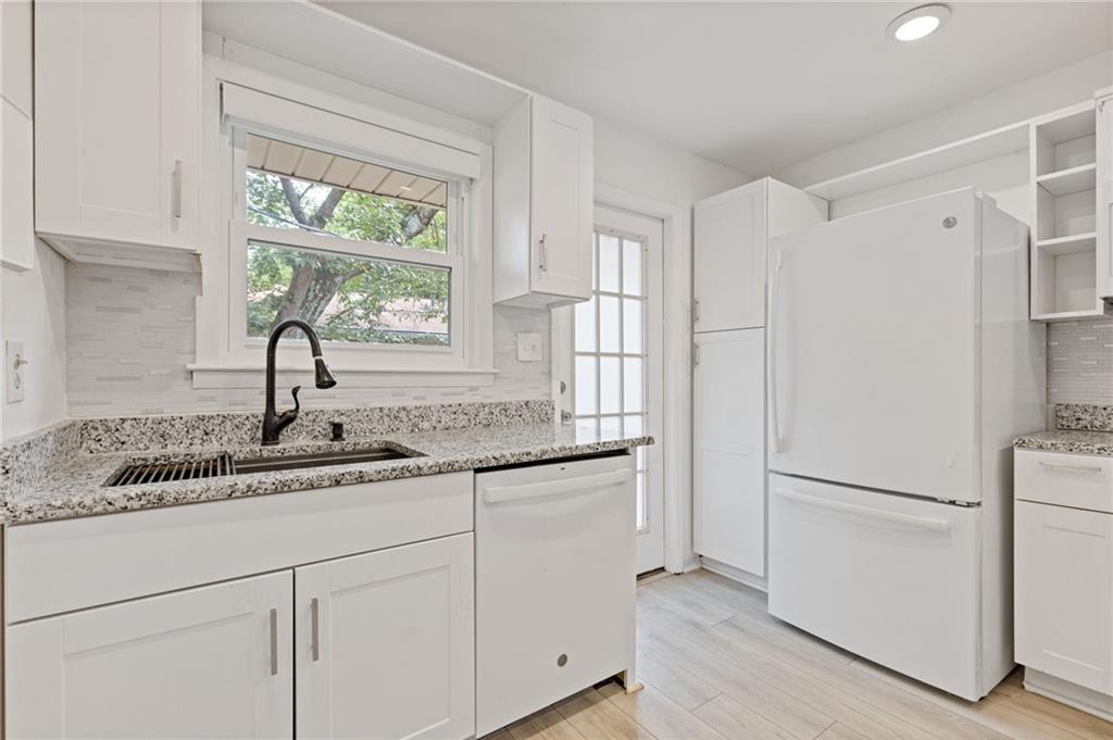3510 Roswell Road, Unit C2 Atlanta, GA 30305 - Photo 9 of 24 a kitchen with stainless steel appliances granite countertop a sink and a refrigerator