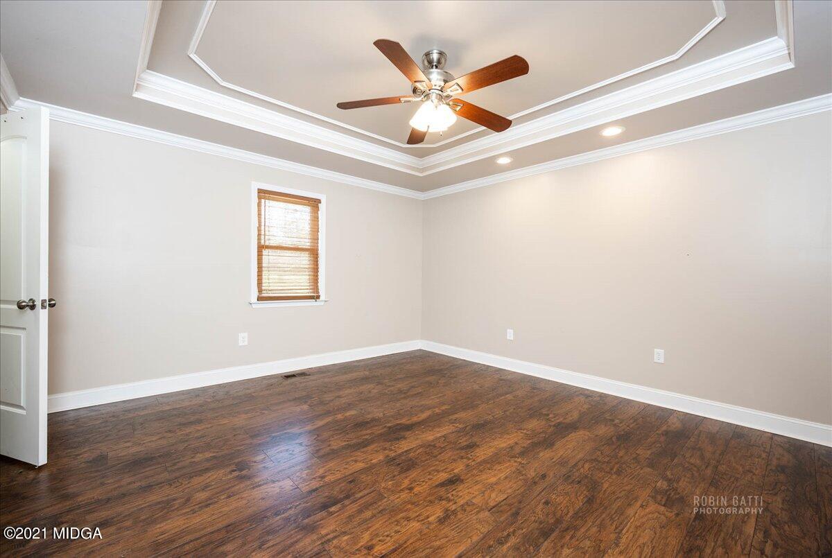 1939 Dames Ferry Road Forsyth, GA 31029 - Photo 11 of 29 an empty room with wooden floor fan and windows