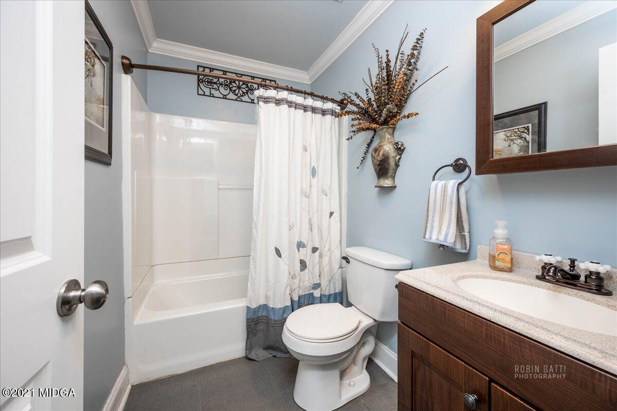1939 Dames Ferry Road Forsyth, GA 31029 - Photo 15 of 29 a bathroom with a sink a toilet and shower