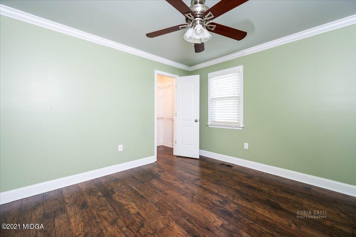 1939 Dames Ferry Road Forsyth, GA 31029 - Photo 17 of 29 an empty room with wooden floor fan and windows