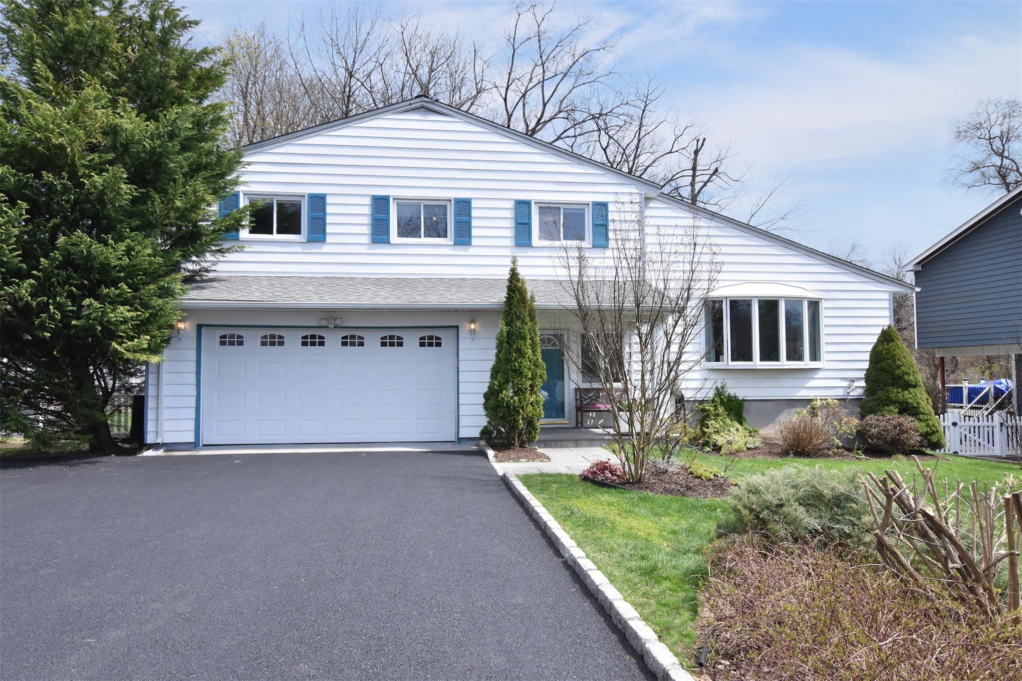 1 Eastern Road Hartsdale, NY 10530 - Photo 1 of 1 View of front of house featuring an attached 2 car garage and brand new driveway. E-Charger in the garage