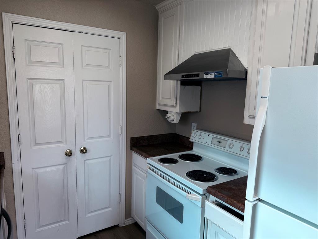 453 Strata Drive Denton, TX 76201 - Photo 13 of 15 a kitchen with a stove and a cabinet