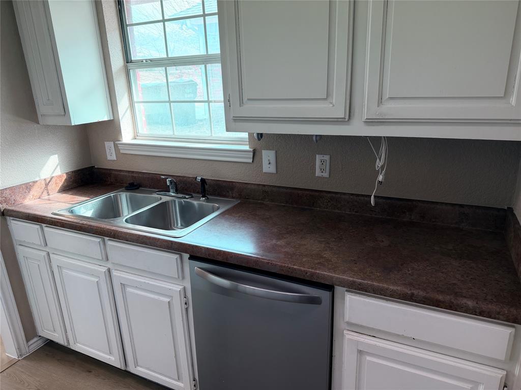 453 Strata Drive Denton, TX 76201 - Photo 14 of 15 a kitchen with stainless steel appliances granite countertop white cabinets and a sink