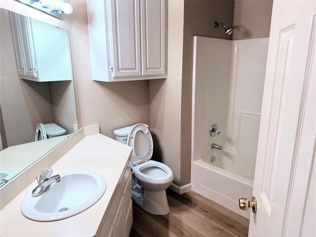 453 Strata Drive Denton, TX 76201 - Photo 10 of 15 a bathroom with a sink toilet and shower