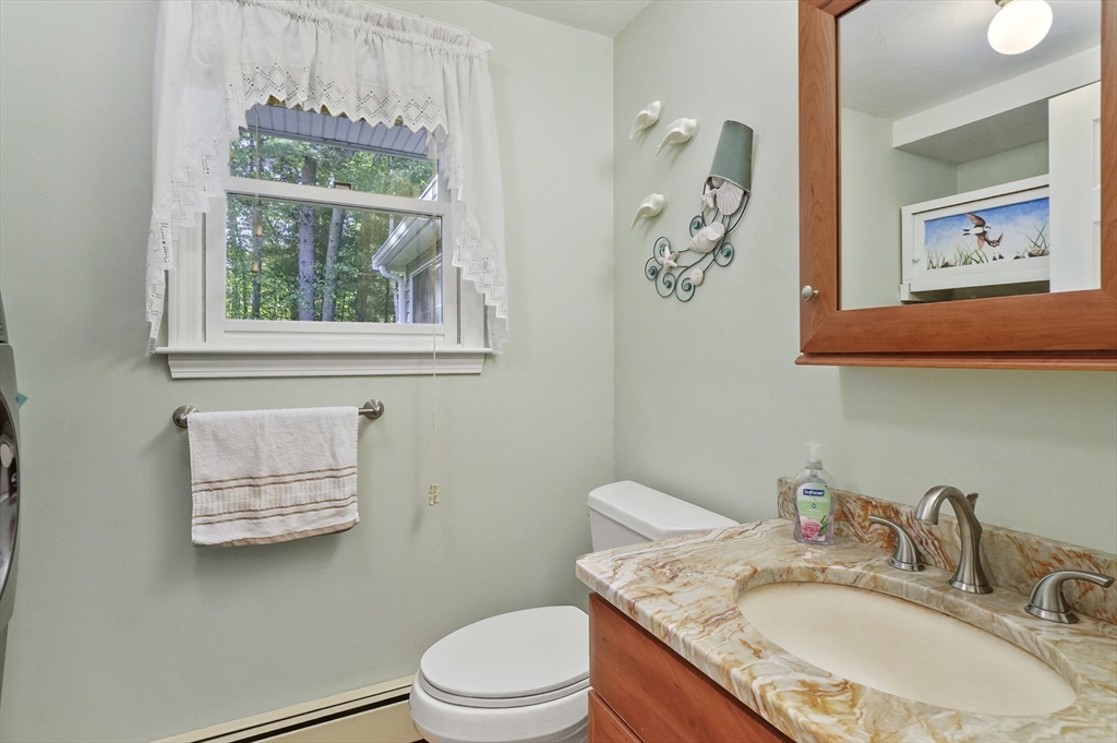 4 Jonathans Way Upton, MA 01568 - Photo 13 of 35 a bathroom with a granite countertop toilet a sink and a mirror