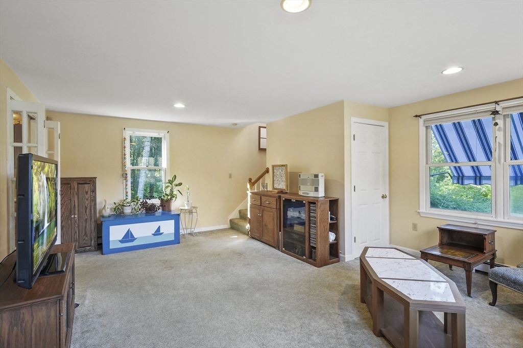 4 Jonathans Way Upton, MA 01568 - Photo 23 of 35 a living room with furniture and a flat screen tv