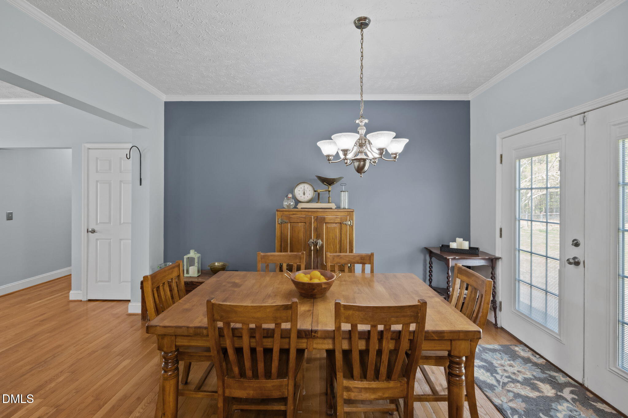 236 Dirgie Mine Road Roxboro, NC 27574 - Photo 24 of 55 a view of a dining room with furniture wooden floor and chandelier