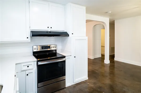 a kitchen with stainless steel appliances granite countertop a stove a microwave and a refrigerator