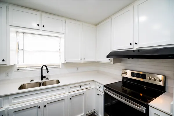a kitchen with a sink and cabinets