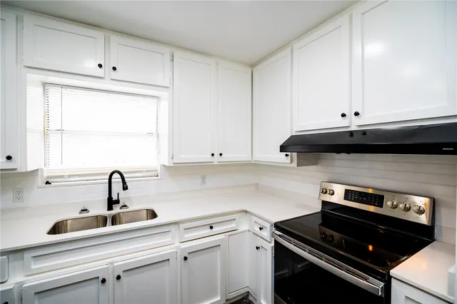 a kitchen with a sink and cabinets