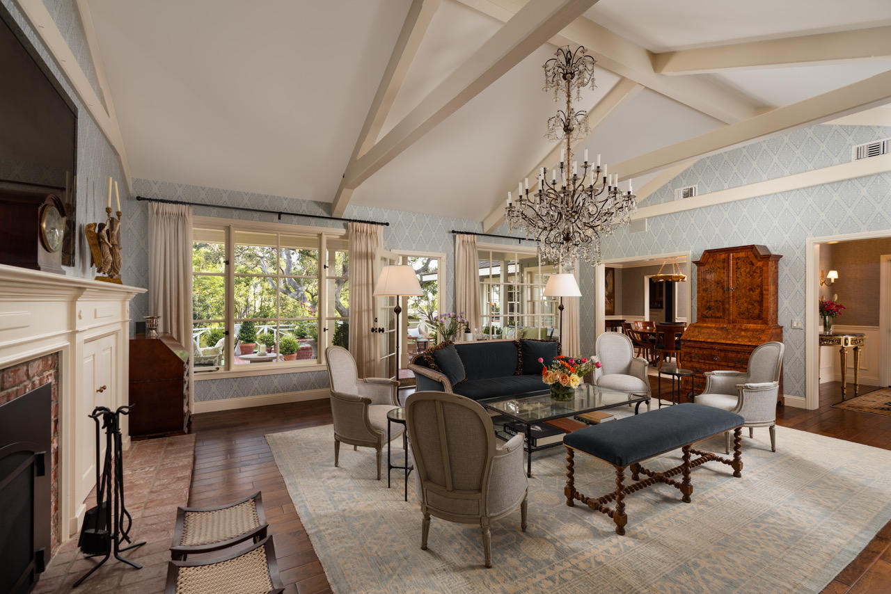 1077 Summit Road Santa Barbara, CA 93108 - Photo 9 of 49 a living room with furniture a chandelier a fireplace and a flat screen tv
