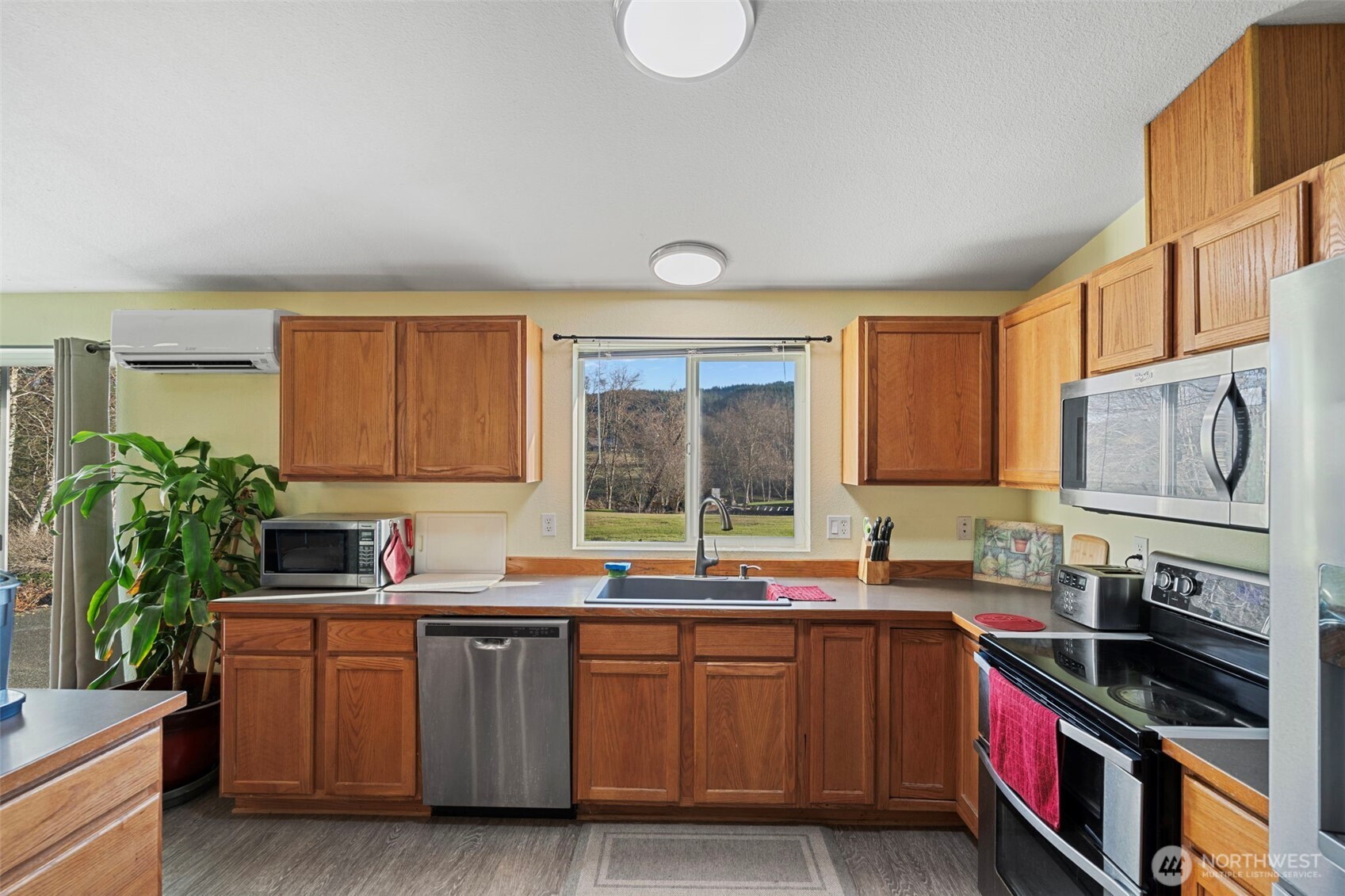 146 Rocky Lane Chehalis, WA 98532 - Photo 16 of 40 a kitchen with stainless steel appliances granite countertop a sink stove and cabinets